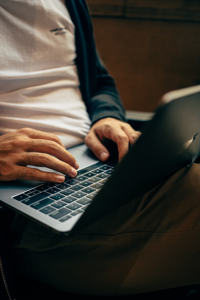 man typing on laptop